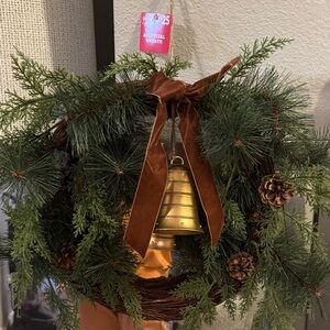 Elegant Holiday Wreath with Gold Bell and Brown Ribbon